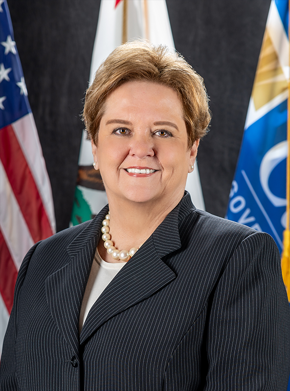 portrait of Nancy Ward with the American, State, and Cal OES flags behind her