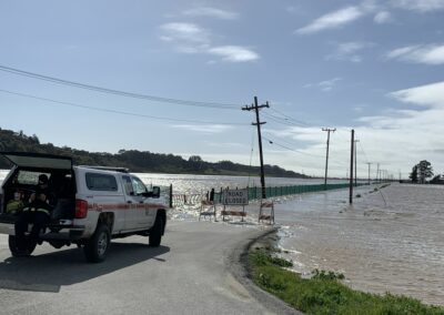 A CalFire truck blocks a flooded road.